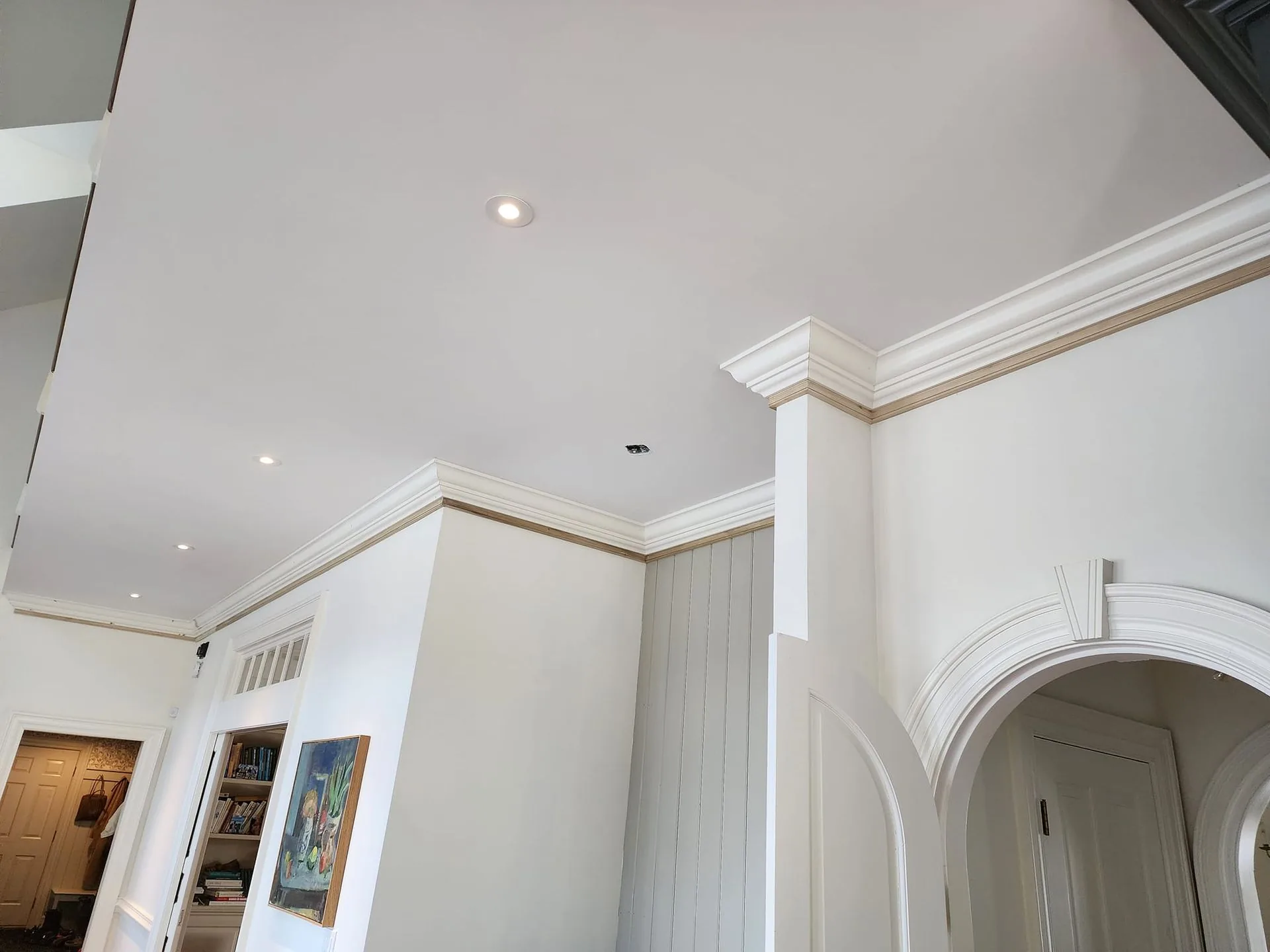 Custom crown molding and trim work with arched doorway